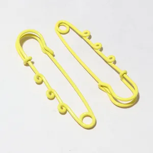 Yellow metal safety pin detail, decorative hanging loops charm, 61x17mm pendant accessory.