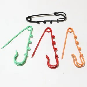 Colorful metal safety pins with hanging loops, decorative DIY pendant charms and craft findings.
