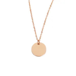 Stainless steel round pendant necklace detail view, polished mirror finish geometric coin jewelry.
