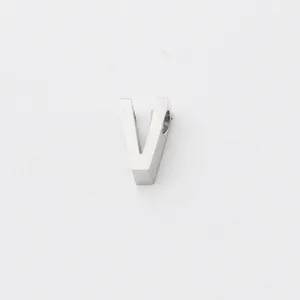 Stainless steel V letter pendant detail close-up, shiny mirror finish jewelry DIY charm.