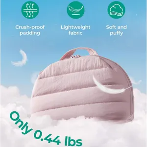 Pink quilted cosmetic bag detail showing puffy soft fabric and lightweight portable design.