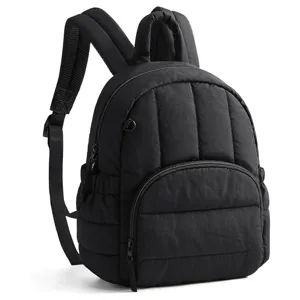 Detailed view of the black quilted backpack showing fine stitching and durable zippers.