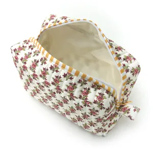 Floral quilted makeup bag with striped zipper, spacious travel cosmetic pouch for women.