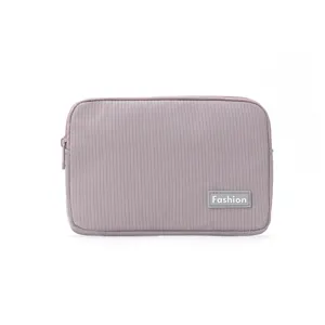 Portable purple cosmetic storage bag, travel makeup pouch with zipper and stylish patch for daily use.