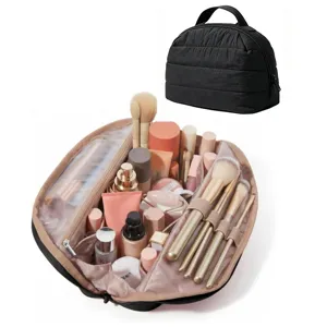 Black quilted cosmetic bag with handle, portable makeup organizer travel toiletries pouch.