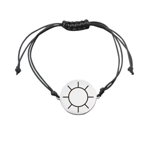 Close-up detail of the minimalist adjustable braided bracelet with laser sun disc pendant.