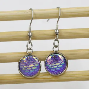 Close-up detail shot of purple fish scale resin drop earrings with stainless steel hooks.