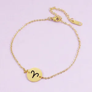 Stainless steel zodiac sign bracelet with mirror polished round pendant charm detail shot.