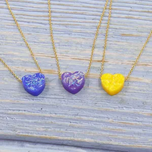 Detailed view of colorful heart opal pendant necklaces showcasing fine chain and resin hearts.