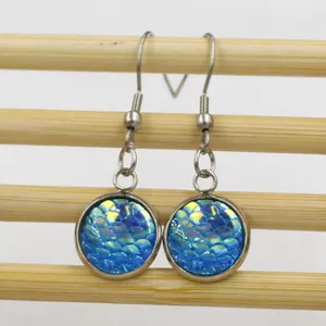 Stainless steel fish scale drop earrings detailed view, showing iridescent blue round cabochons.