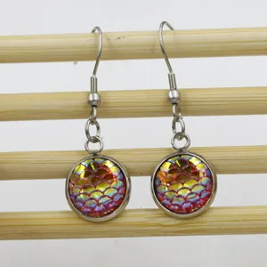 Detailed close-up shot of the stainless steel fish scale pattern drop earrings, showing texture.