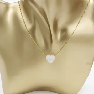 Gold stainless steel clavicle chain necklace with a white heart opal pendant detail view.