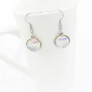 Close-up detail of mermaid fish scale design drop earrings featuring shiny resin cabochons.