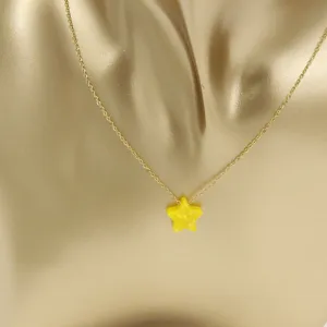 Detailed close-up of a gold stainless steel chain necklace with a yellow resin star pendant.