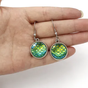Detailed view of shiny mermaid scale resin drop earrings featuring stainless steel hooks.