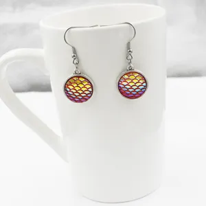 Detailed close-up shot of mermaid scale resin earrings with stainless steel hooks detail