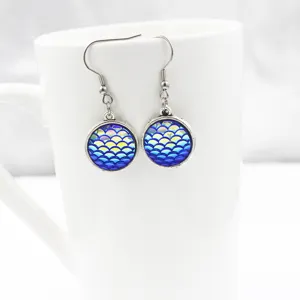 Detail view of mermaid scale resin earrings with stainless steel hooks for daily wear.