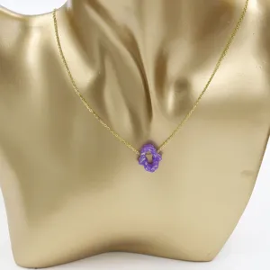 Gold stainless steel clavicle chain necklace with a purple hollow hamsa hand resin pendant.