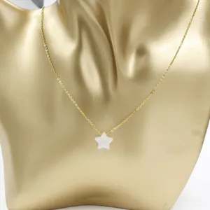 Close-up detail of the gold stainless steel chain necklace featuring a white resin opal star pendant.