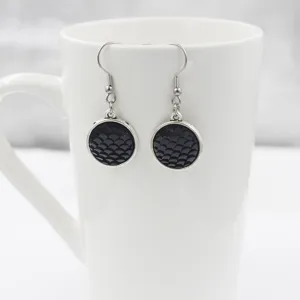 Elegant black mermaid scale earrings featuring round resin pendants and durable silver hooks.