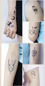 Waterproof temporary tattoo stickers with cute black animals and celestial designs for body art.