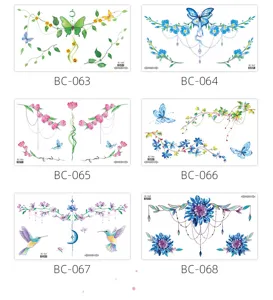 Close up details of colorful floral and butterfly temporary chest tattoo sticker designs.