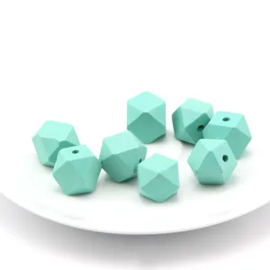 Detailed view of turquoise faceted wooden beads, perfect for DIY jewelry making and crafts.