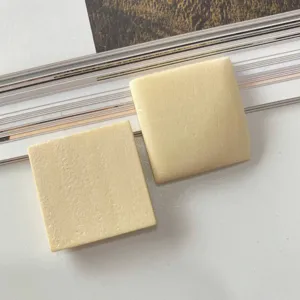 Detailed view of DIY handmade polished square wooden earring components, smooth parts.