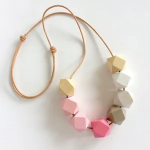 Handmade faceted wooden bead necklace with adjustable cord, colorful geometric jewelry detail.