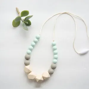 Detailed view of handmade beaded necklace with mint green, grey and beige faceted beads.