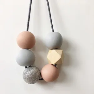 Close-up of DIY wooden beads necklace with multi-faceted octagonal beads and colorful round beads.