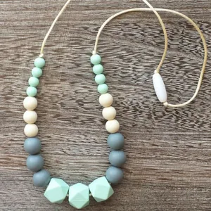 Silicone teething necklace with geometric faceted beads and secure clasp for baby moms.