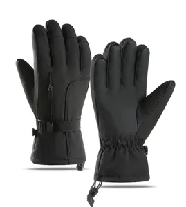 Detailed view of black winter ski gloves featuring waterproof fabric and adjustable wrist straps.
