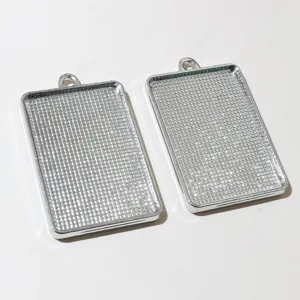 Detailed shot of alloy rectangular bezel pendant trays for DIY jewelry crafts making accessories.