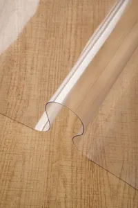 Close-up detail of clear PVC soft glass tablecloth, waterproof table protector mat.