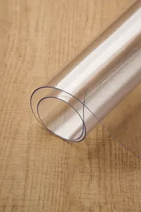 Transparent PVC table cloth detail, waterproof and wear-resistant soft glass mat surface.