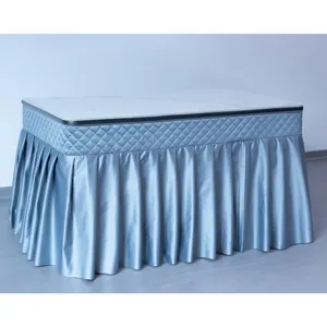 Minimalist blue quilted table cover for heating table and tea table with elegant pleated skirt.