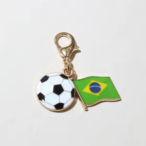 Detailed view of a metal enamel Brazil flag and soccer ball charm with lobster clasp for DIY crafts.