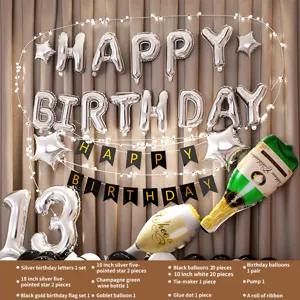 Birthday party decoration set with silver foil balloons, star balloons, and atmospheric lights.