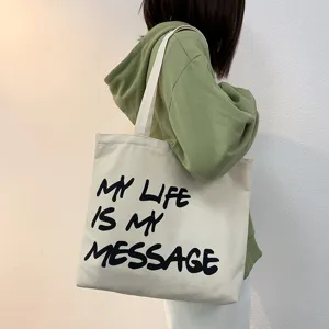 Casual canvas shoulder bag for women, large capacity daily tote with stylish letter print.