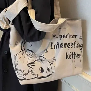 Canvas tote bag detail close-up showing cute cat graphic and letter print design for daily use.