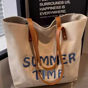 Large capacity canvas tote bag for women with embroidered blue letters casual shoulder bag.