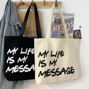 Canvas tote bag with letter print, casual large capacity shoulder bag for student daily commute.