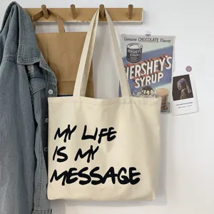 Casual canvas tote bag with letter print, large capacity shoulder bag for student daily commuting.