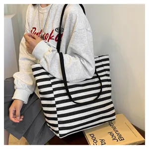 Details of black and white striped canvas tote bag, large capacity casual shoulder bag for women.