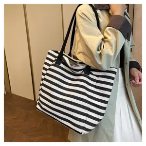 Black and white striped canvas tote bag, large capacity shoulder handbag for women daily commuter fashion.