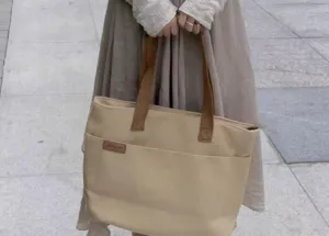 Casual canvas tote bag with brown handles, large capacity shoulder bag for daily commute.