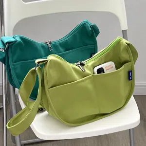Canvas crossbody shoulder bag detail, casual daily student handbag with front pockets.