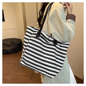Detail shot of striped canvas tote bag, large capacity for daily commute and casual use.