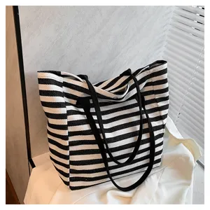 Classic black and white striped canvas tote bag, large capacity daily commuter handbag.